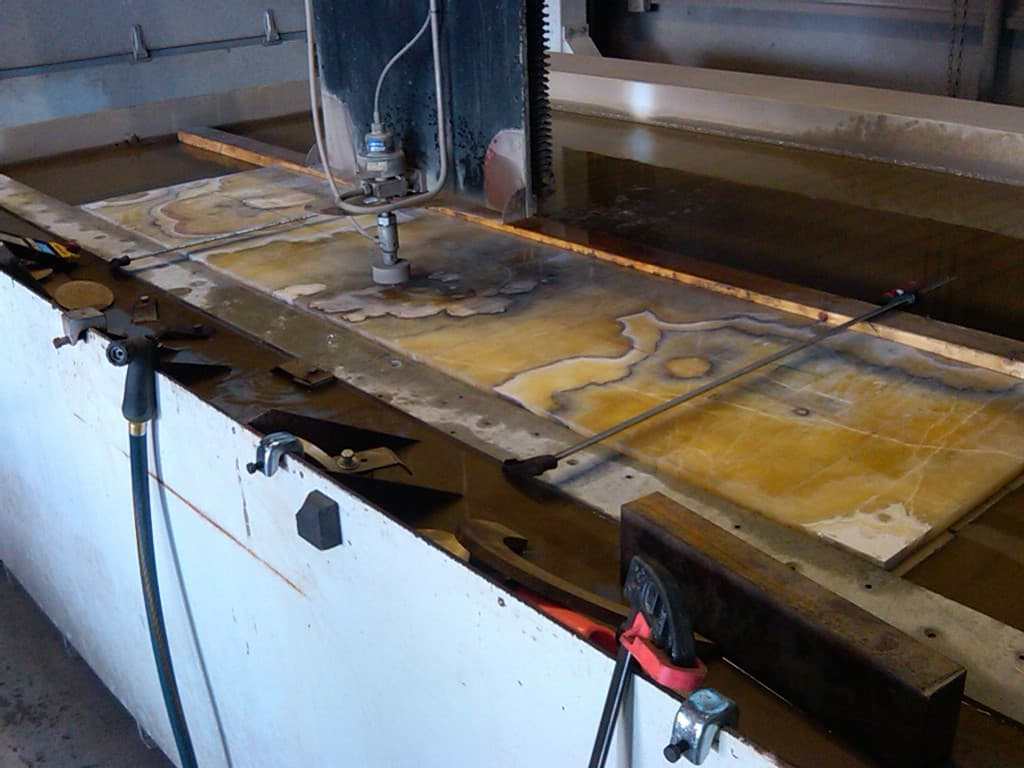 Waterjet cutting table and cut stone profiles from the Fab Metal Shop photograph archive
